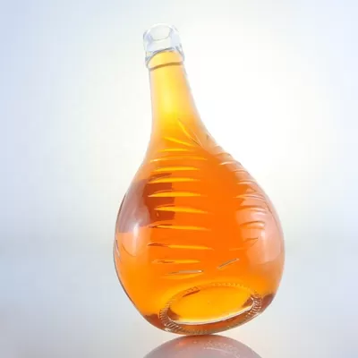 Champagne-colored 1-liter glass bottle with custom options of decal screen printing and cork seal